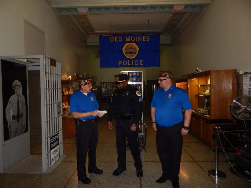 Senior Vice Dennis Applehous and Junior Vice Chris McClaskey present a donation check to Des Moines police Sgt. Bernell Edwards. The check was to support the DSM PD Honor Guard and their continued mission.
